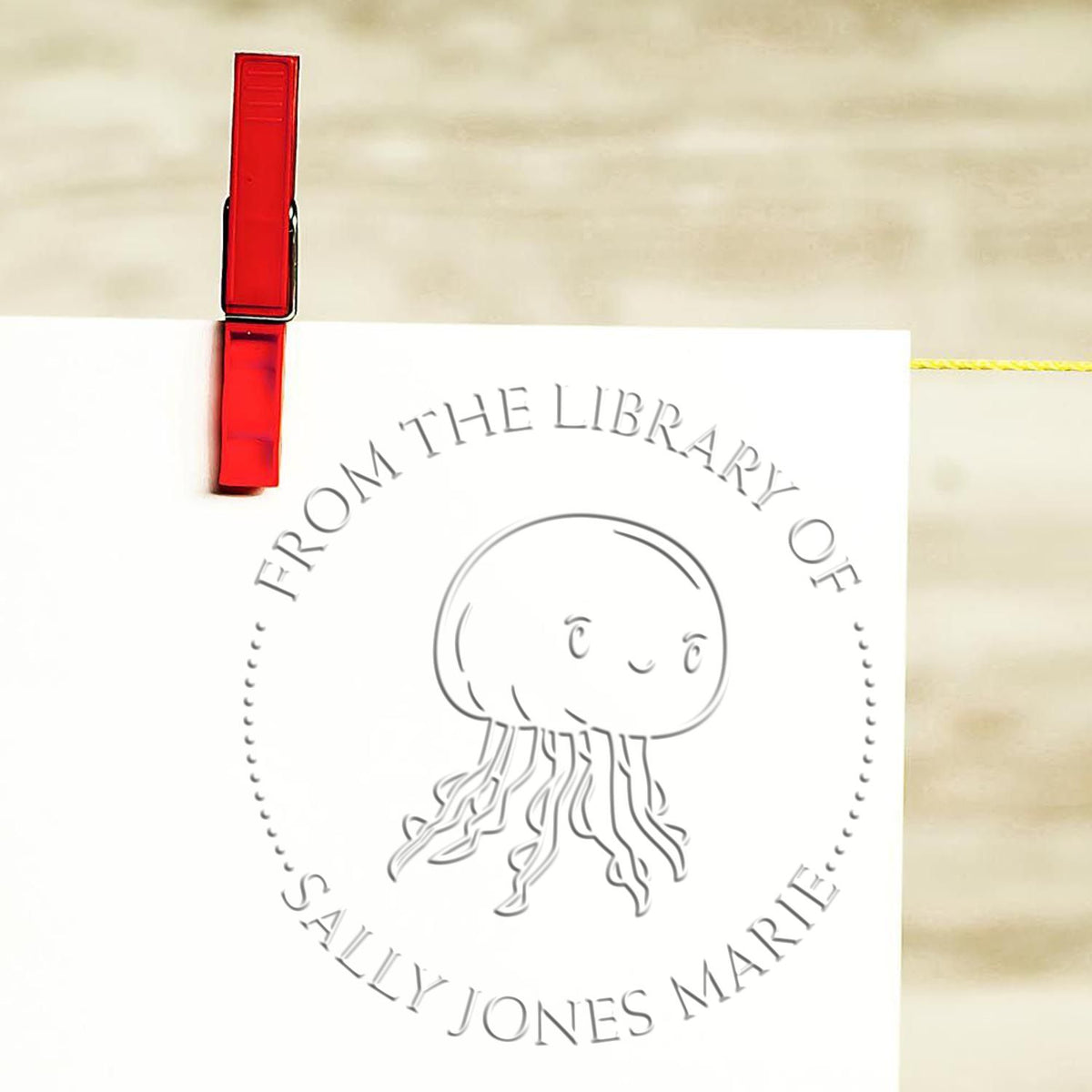 Shiny soft floating jellyfish animal stamp in use, custom-made seal stamp for crafting and stamping projects.