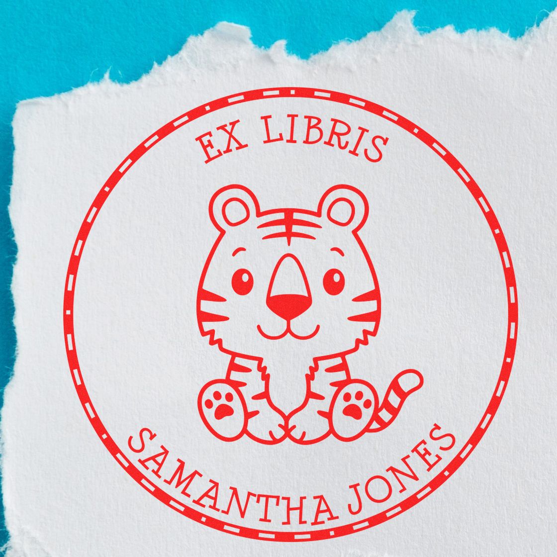 Red ex libris tiger stamp seal on torn white paper against bright blue background.