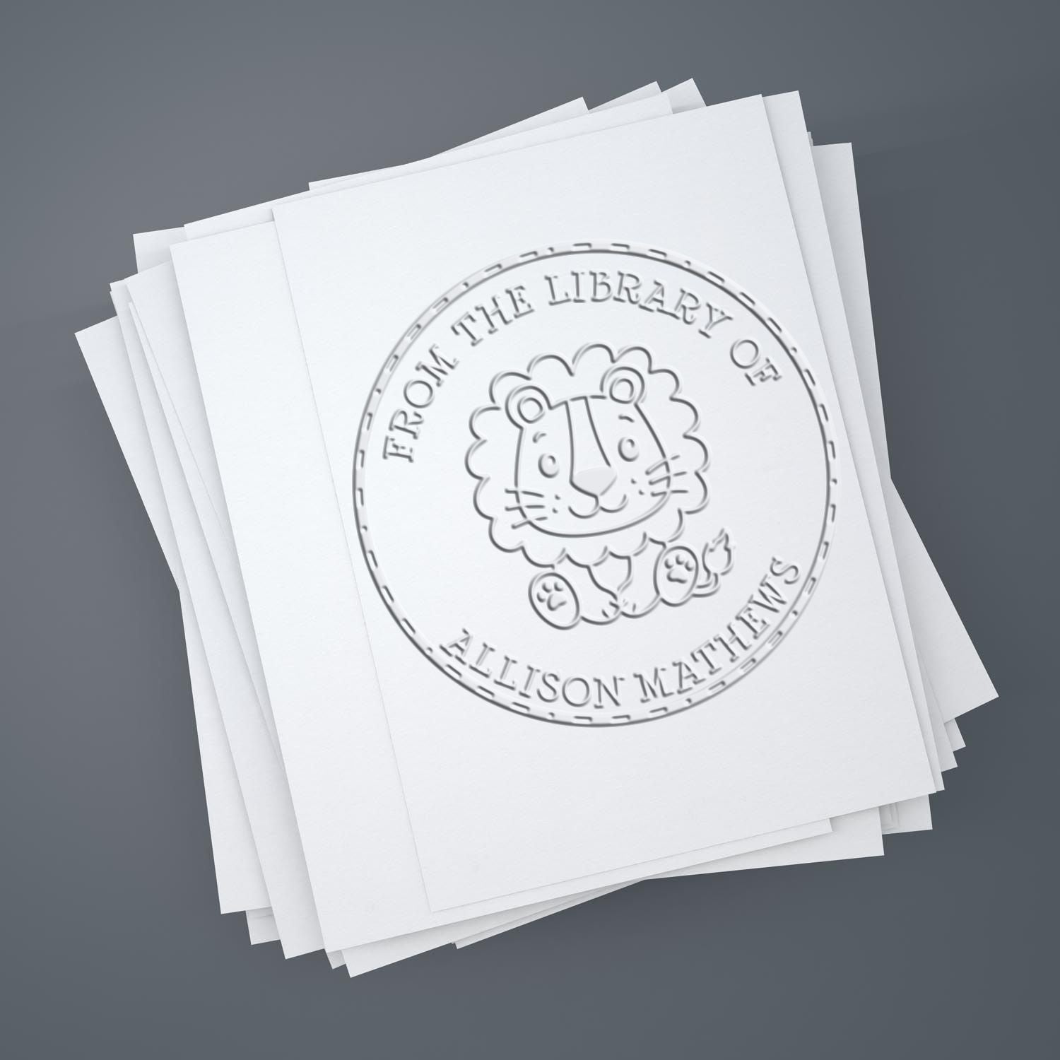 Stack of white papers with embossed circular library stamp and seal, featuring a lion emblem, on gray background.