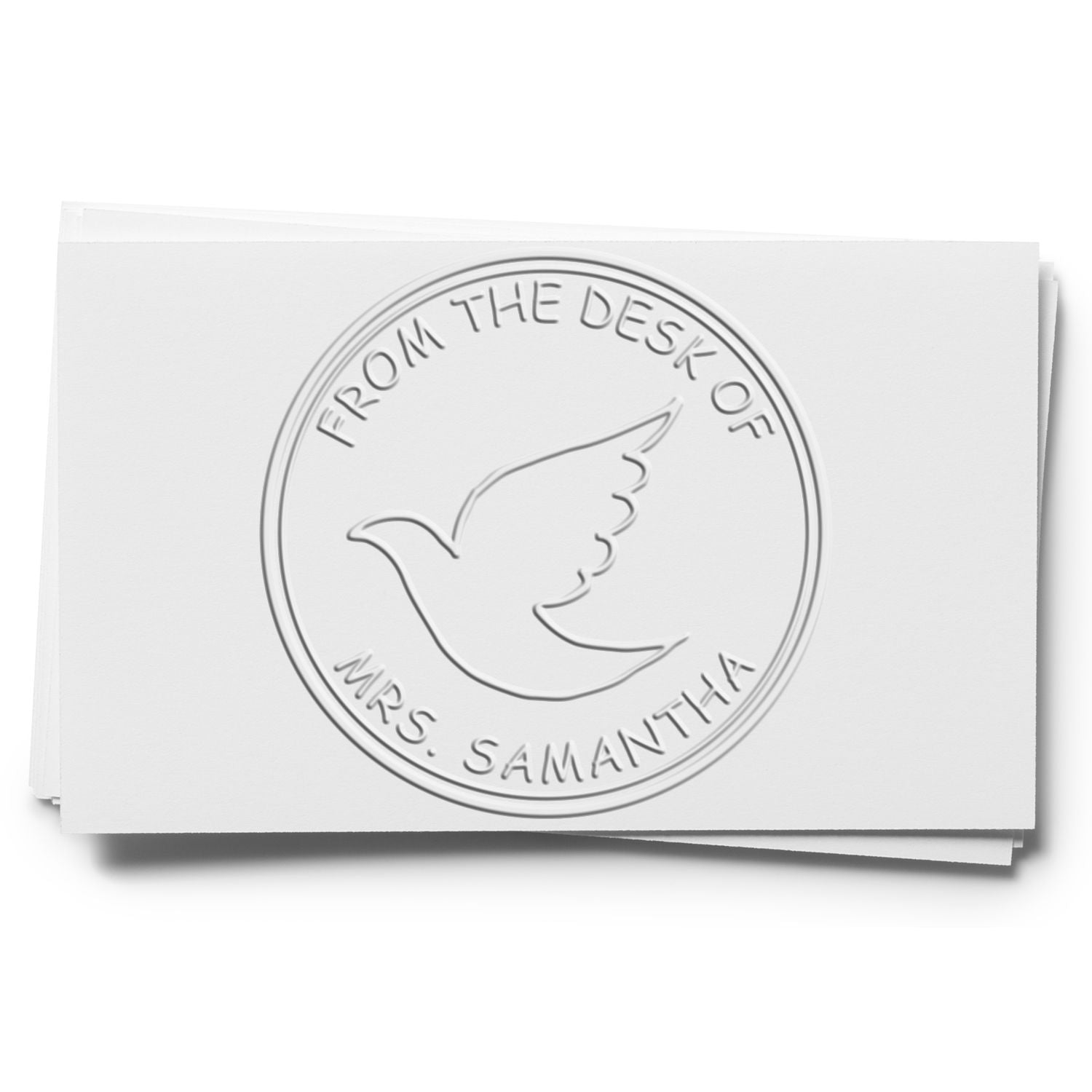 Embossed white desk seal stamp with dove emblem and From the Desk of Mrs. Samantha circular text.