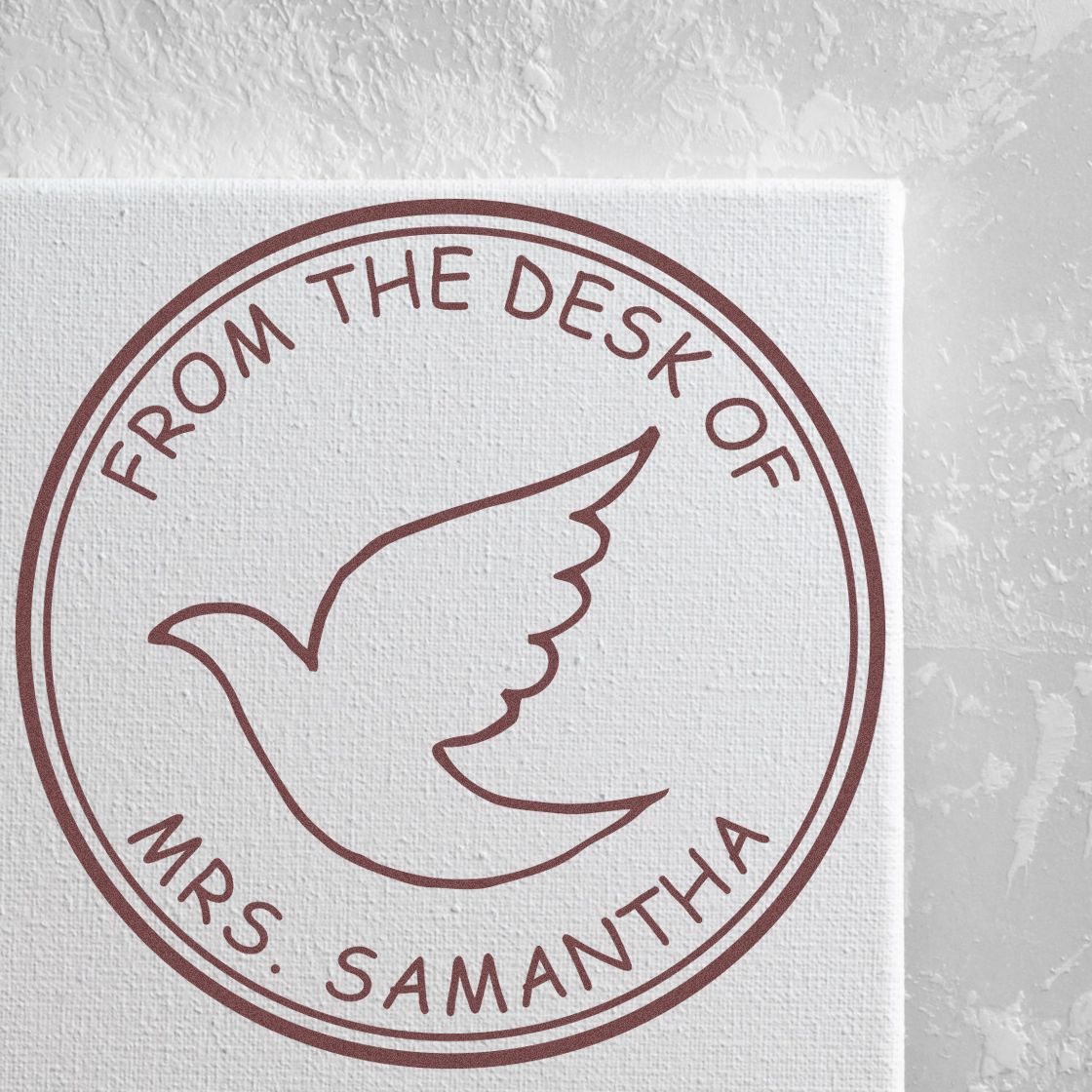 Maroon circular stamp seal with dove icon and From the Desk of Mrs. Samantha on white textured paper.