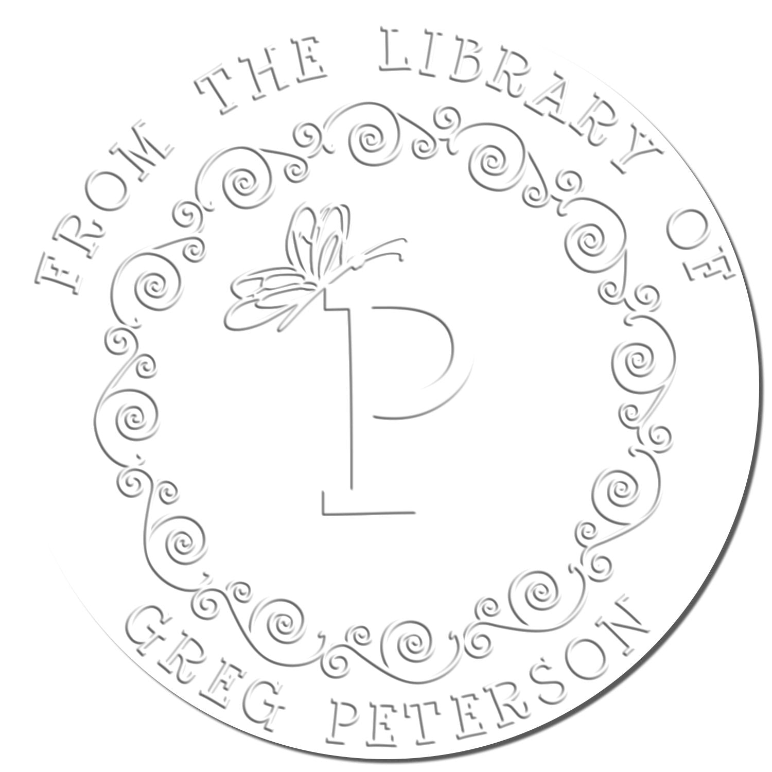 Silver-gray circular library stamp seal with ornate swirls, dragonfly monogram P, and THE LIBRARY OF GREG PETERSON text.