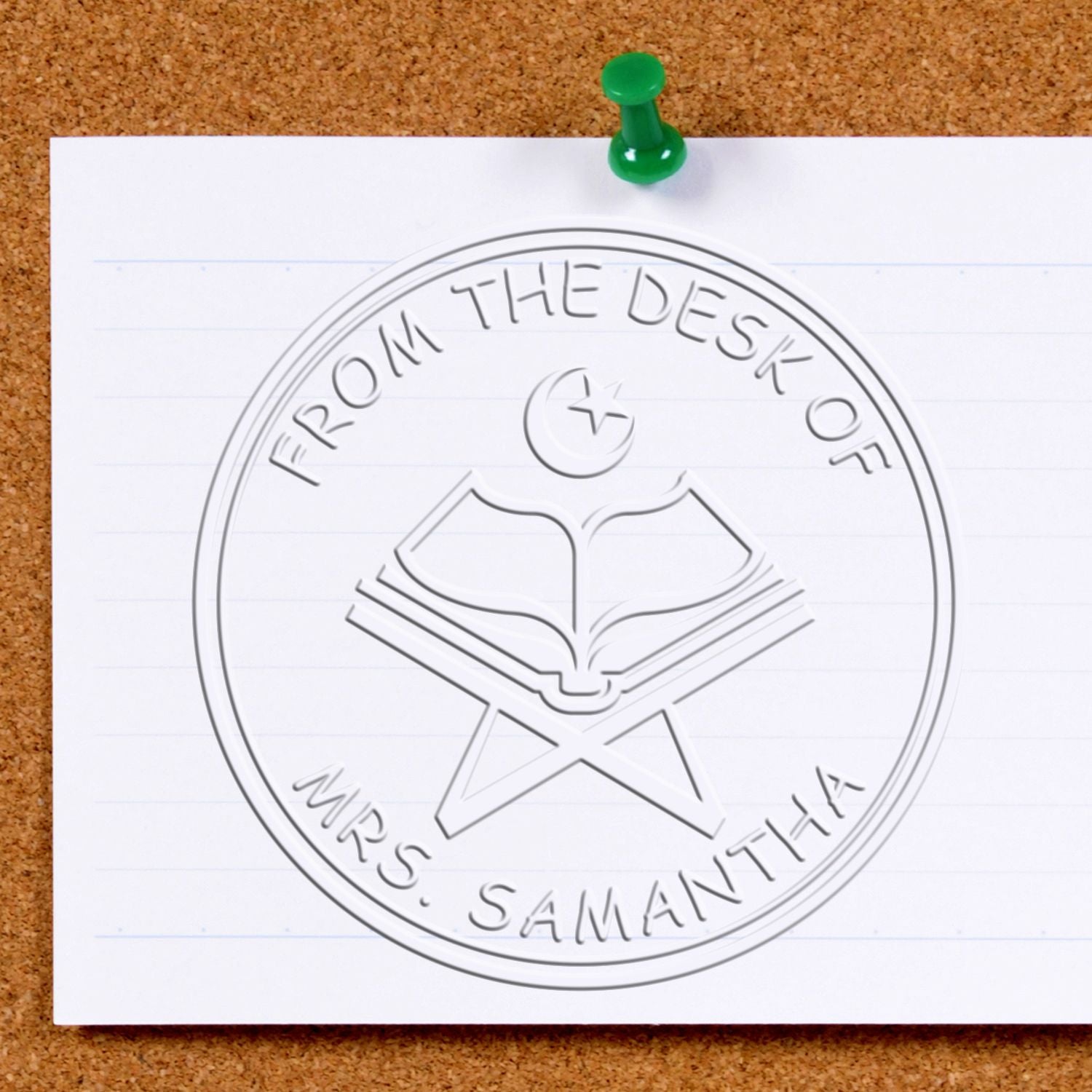 Green push pin holds white paper with an embossed round seal stamp reading From the Desk of Mrs. Samantha and an open book icon.