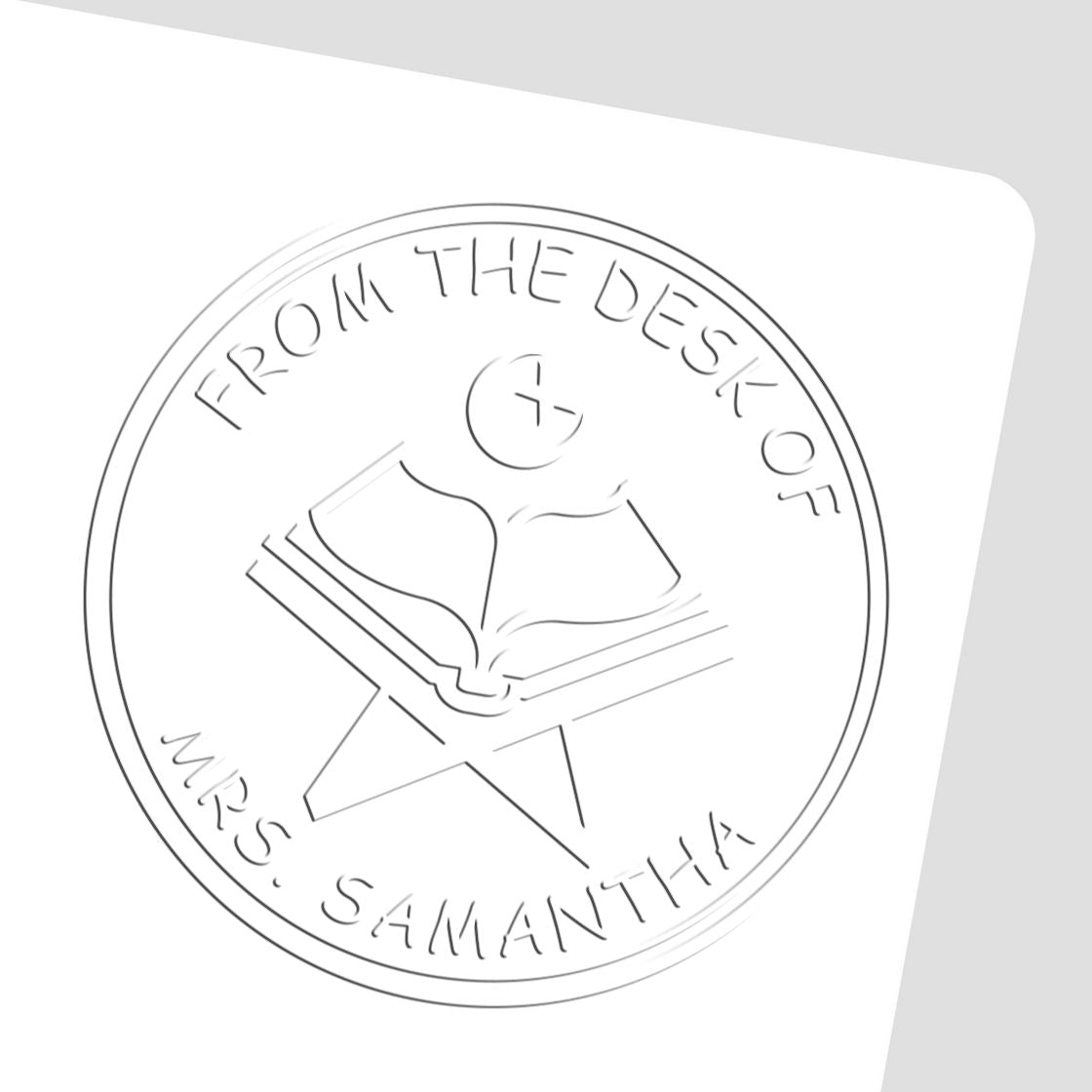 Circular white desk seal stamp with gray embossed open book and star, reading From the Desk of Mrs. Samantha.
