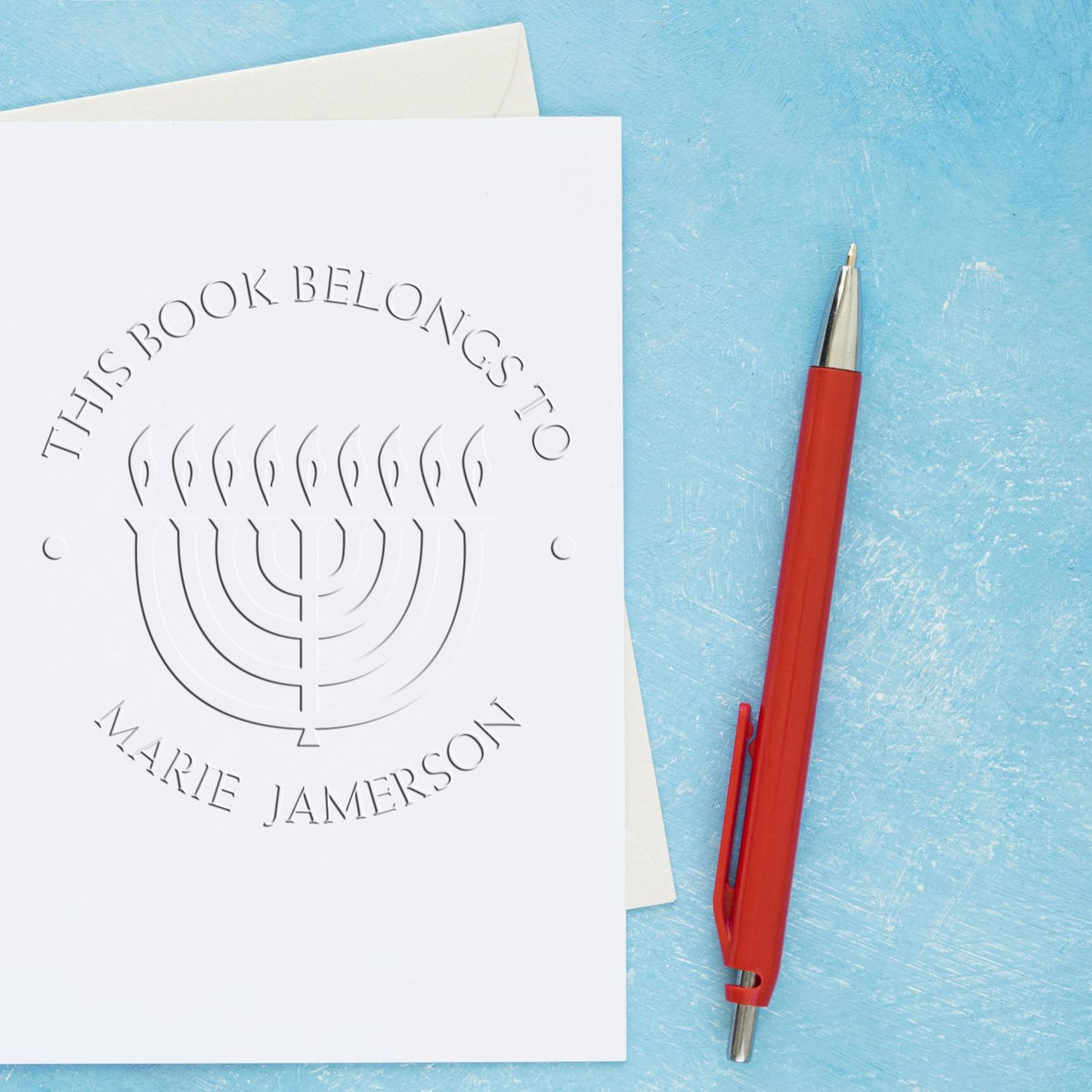 Shiny Soft Bright Menorah Custom Envelope Seal Stamp in use, featuring a religious menorah design on the stamp surface.