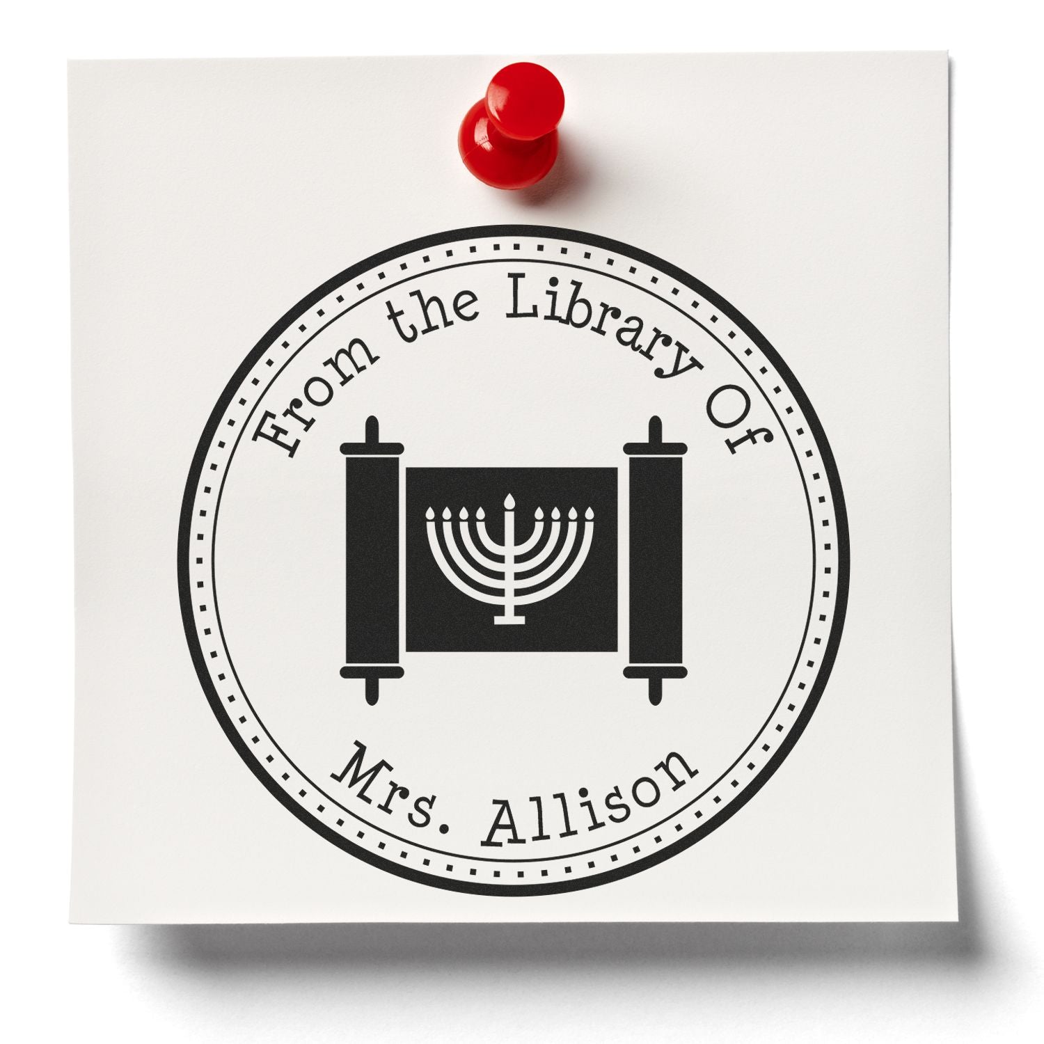 Custom black library seal stamp with red push pin, white paper, scroll and menorah, reading From the Library Of Mrs. Allison