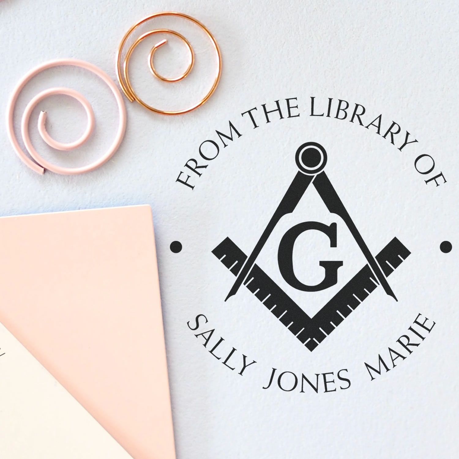 Custom black Masonic seal stamp with gold and blush wax seal samples on white paper