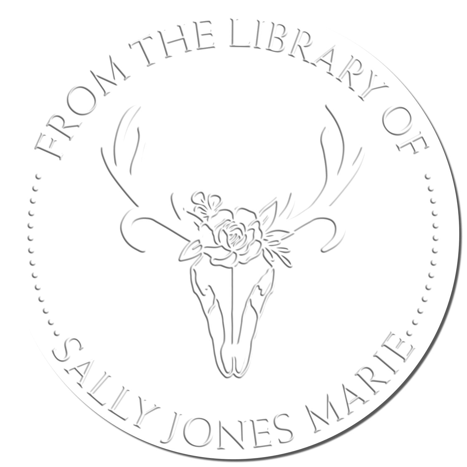 White embossed library stamp seal with deer skull and flowers, reading From the Library of Sally Jones Marie.