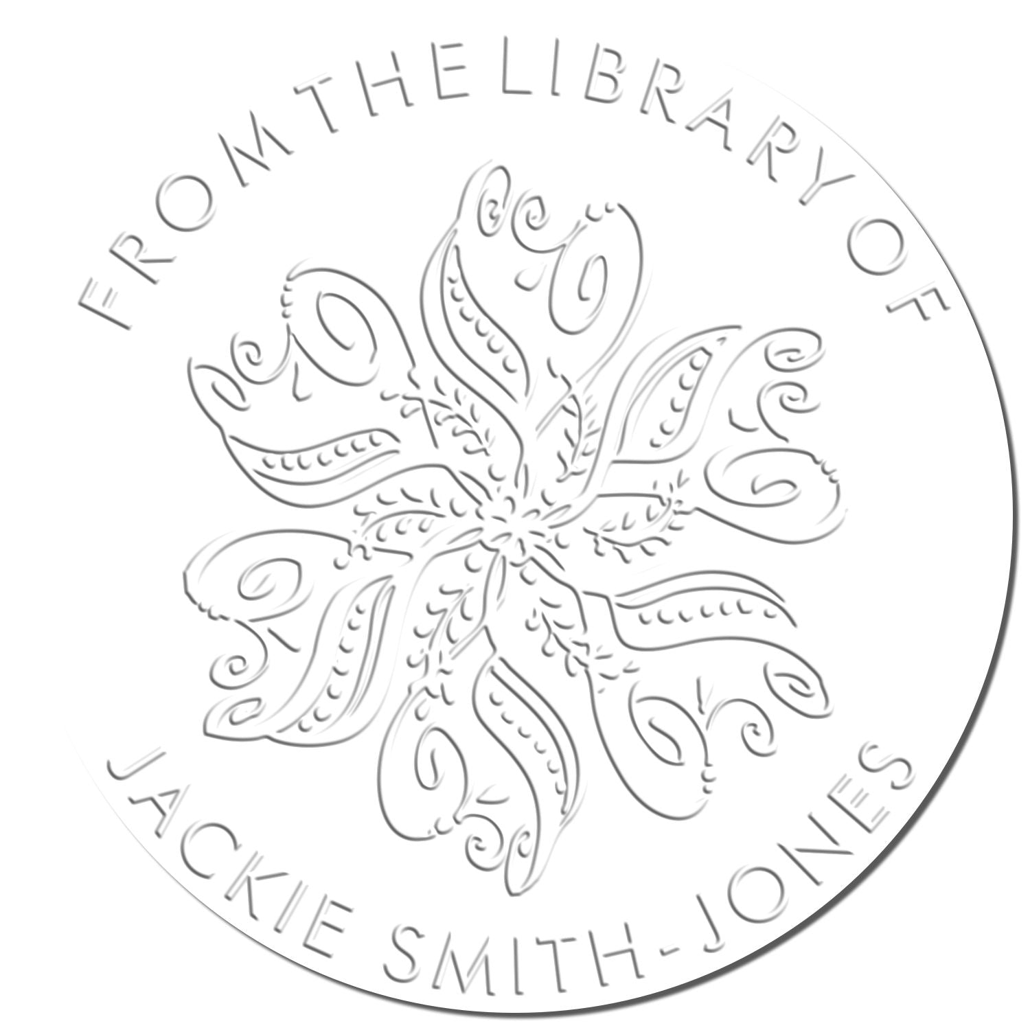 Embossed gray circular library stamp seal with floral line art and From the Library of Jackie Smith-Jones on white.