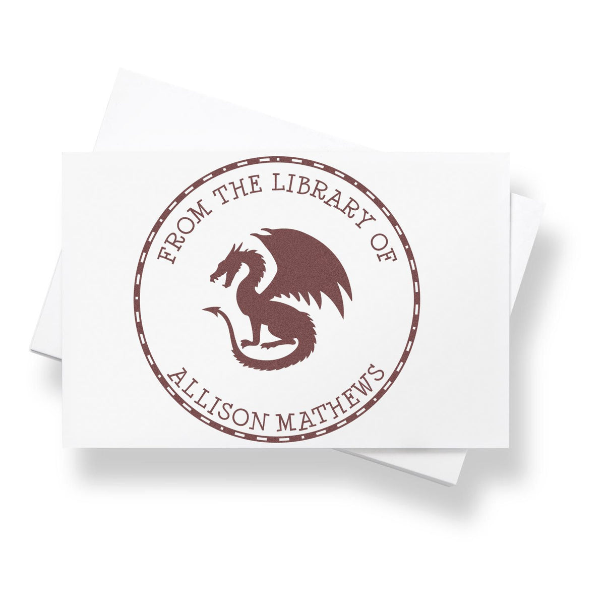 Brown custom library stamp and seal with a dragon emblem and circular text on a white card