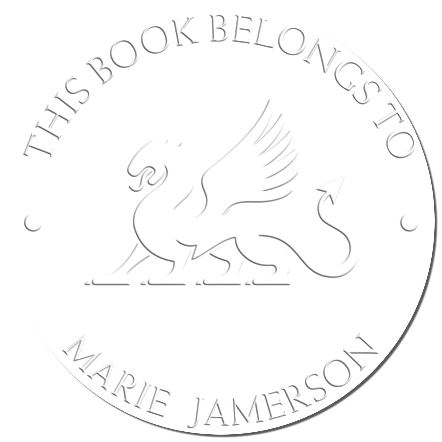 White circular book stamp seal with a rearing horse and This Book Belongs to Marie Jamerson around the edge.