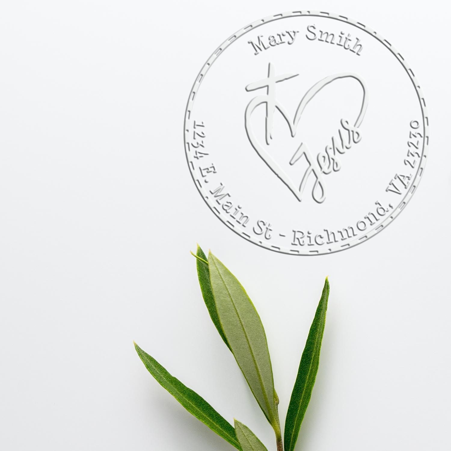 Embossed white circular seal stamp with Mary Smith text and heart logo above green leaves on a clean white background.