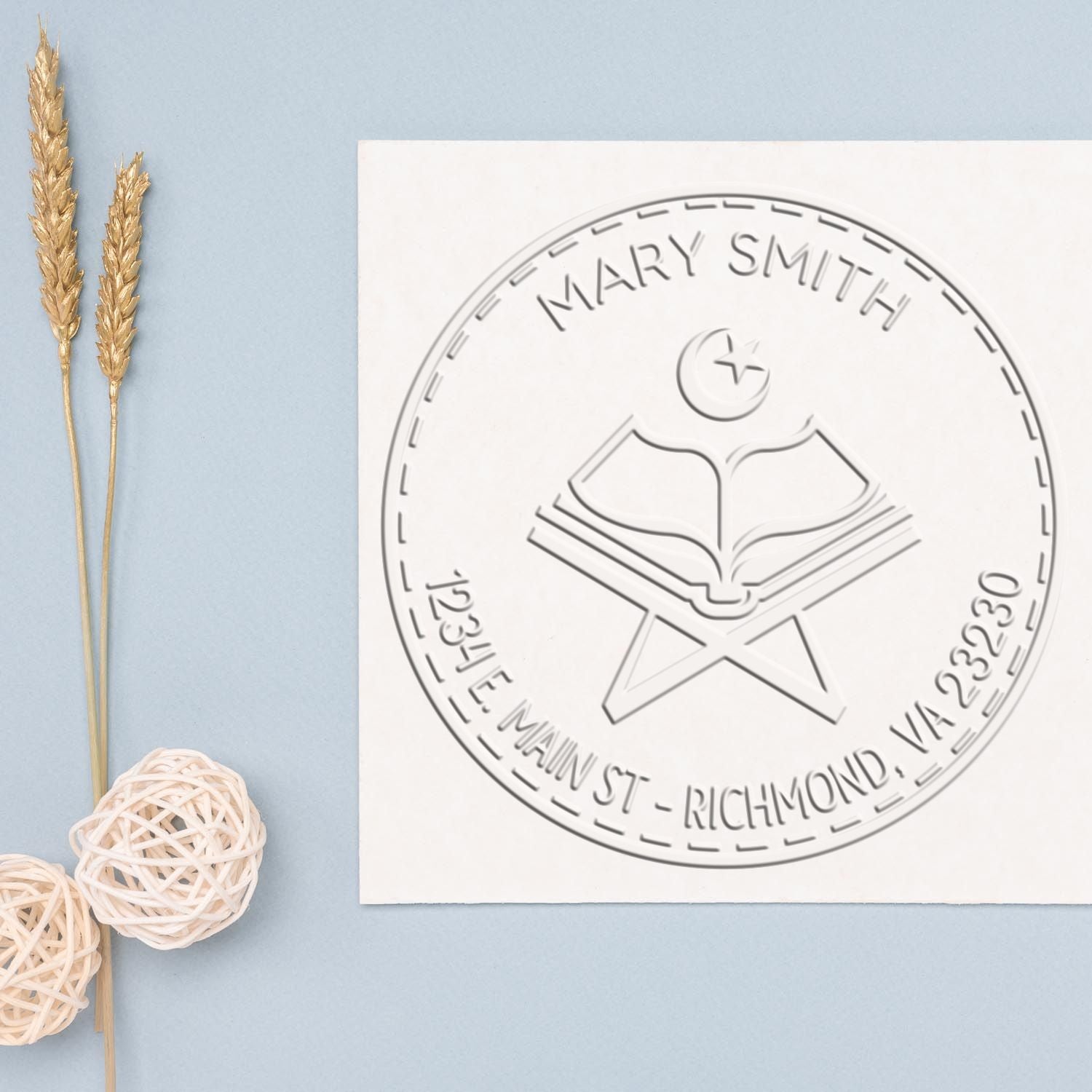 White custom stamp seal for Mary Smith with book emblem, on pale blue background and gold wheat stems.