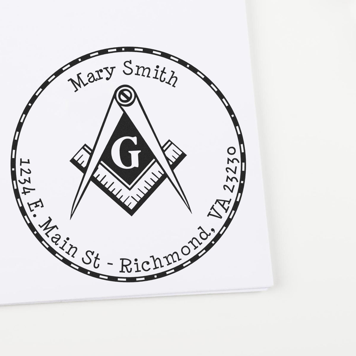 Black-and-white custom stamp seal with Masonic compass and G, reading Mary Smith, 1234 E. Main St., Richmond, VA 23230.