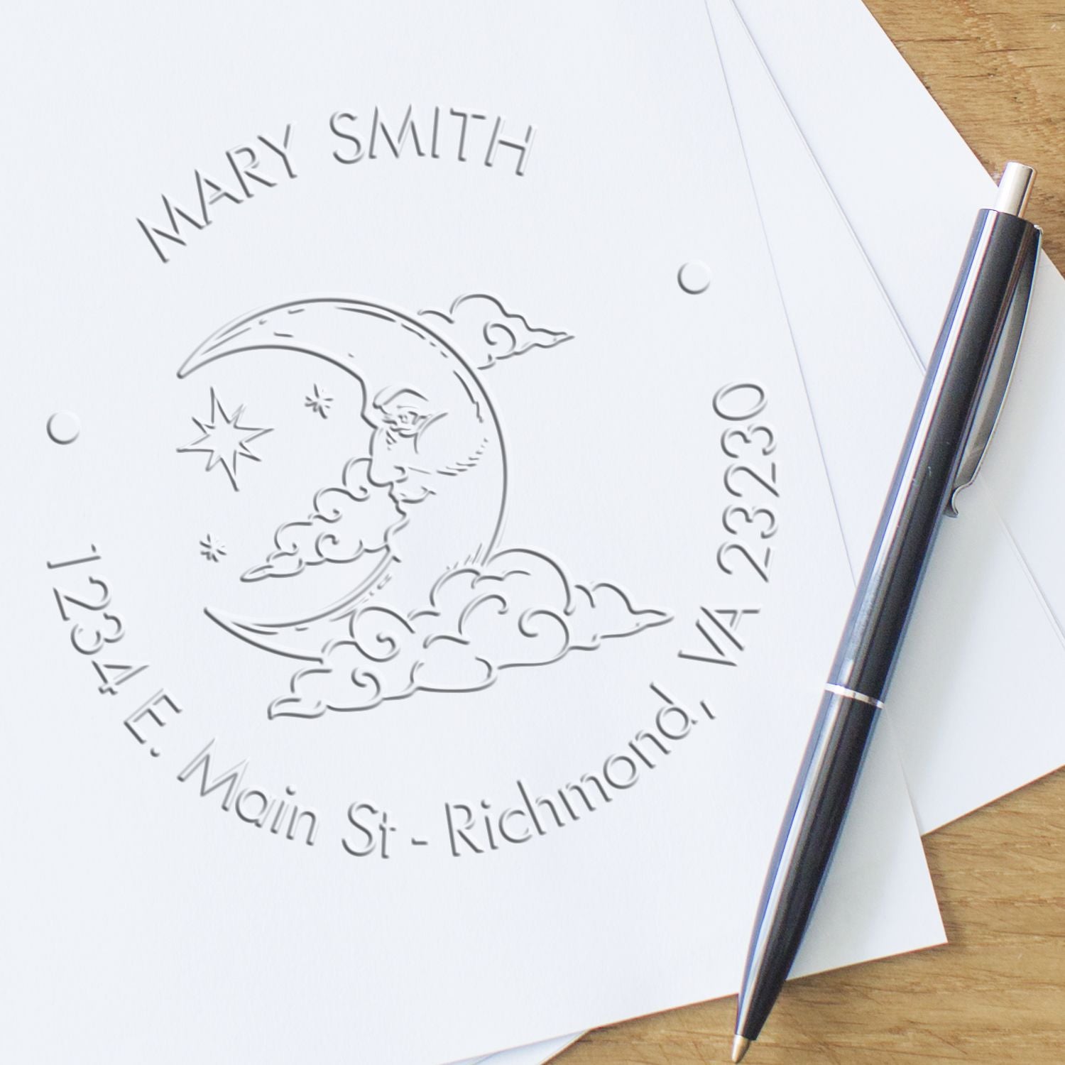 Shiny astrological envelope embossing stamp with moon design in use, creating elegant embossed seals on paper.