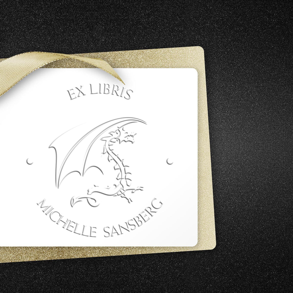 Shiny Soft Crystal Gaze personalized book ownership embosser featuring a fantasy-themed stamp in use on a book page.
