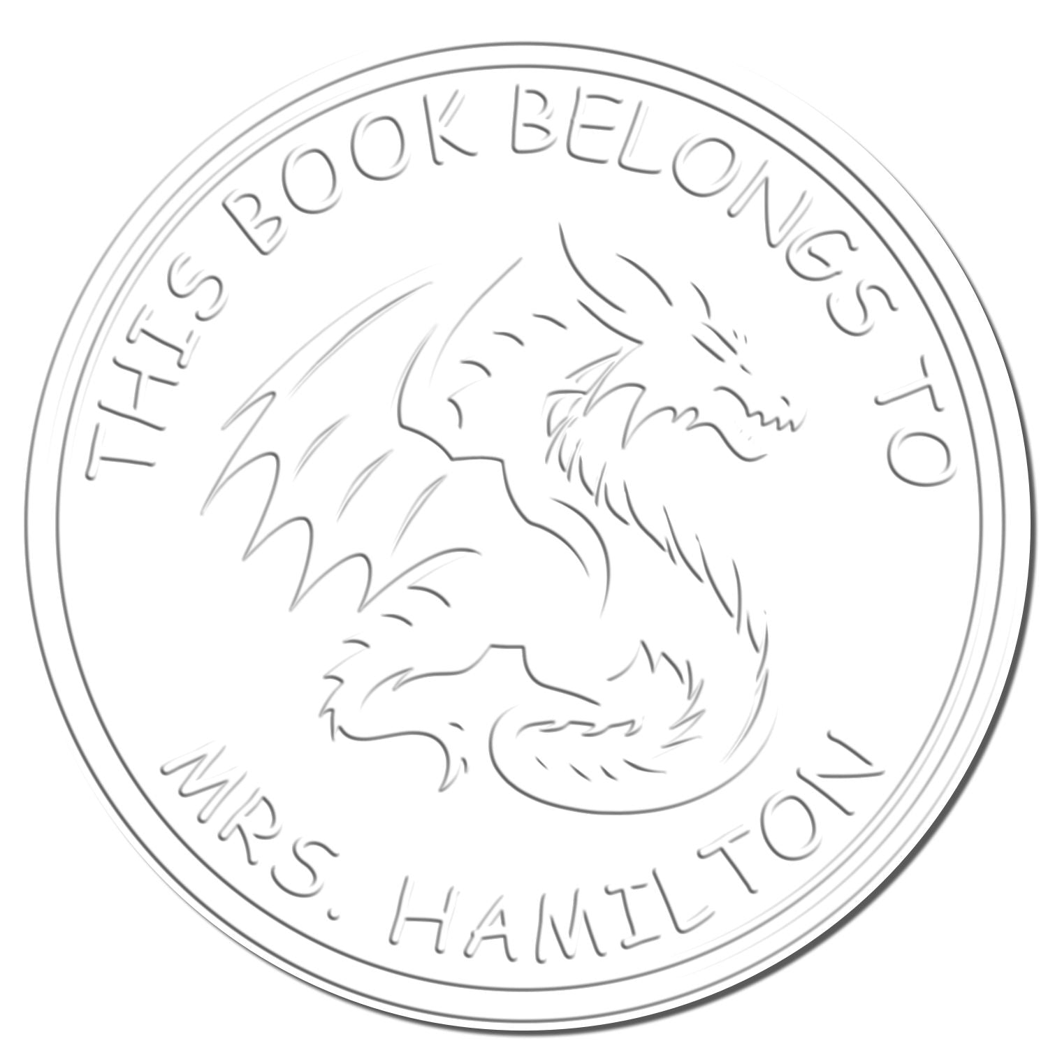 White circular book ownership stamp seal with gray dragon outline and curved text: This Book Belongs to Mrs. Hamilton.