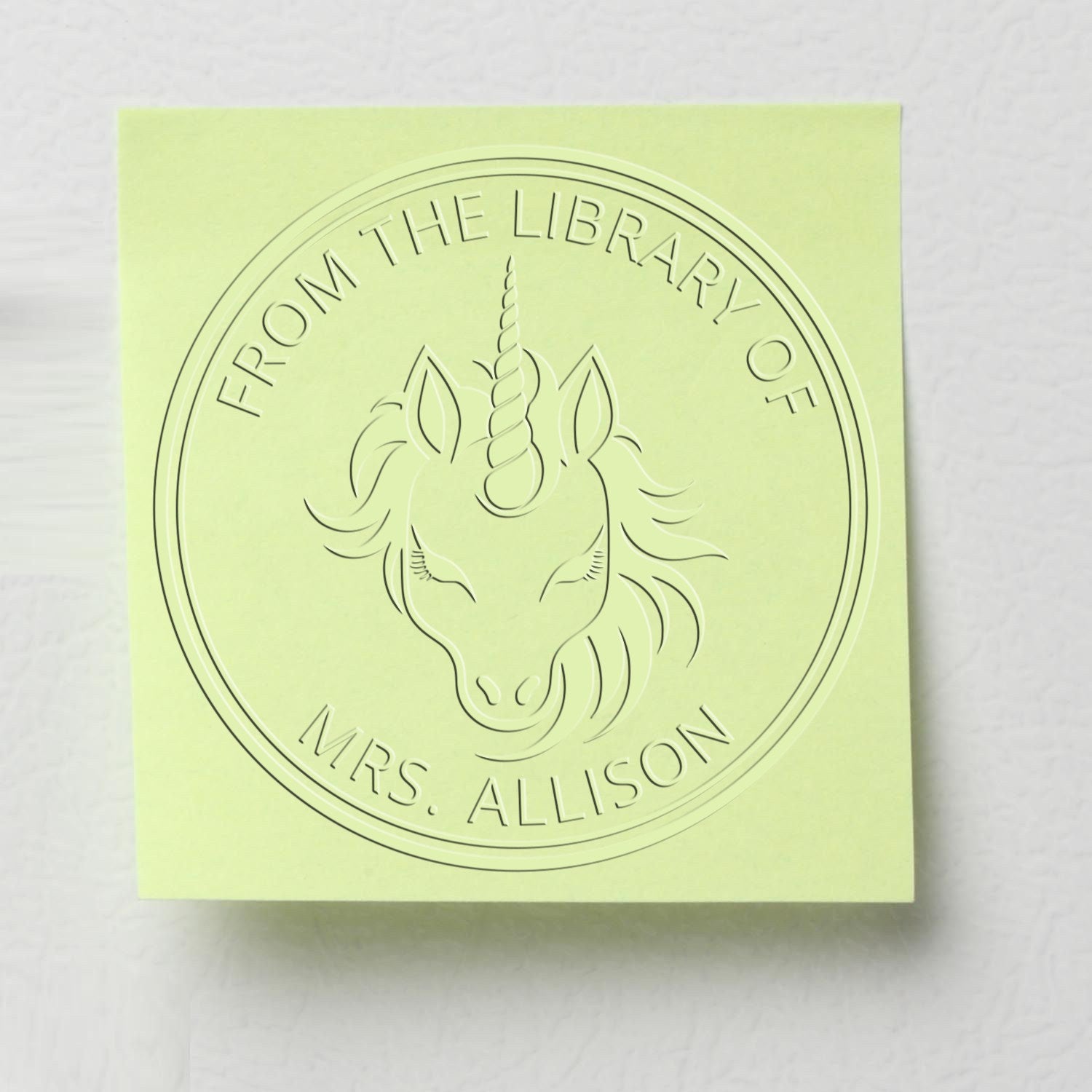 Pale green embossed library stamp seal with unicorn and circular text, From the Library of Mrs. Allison.