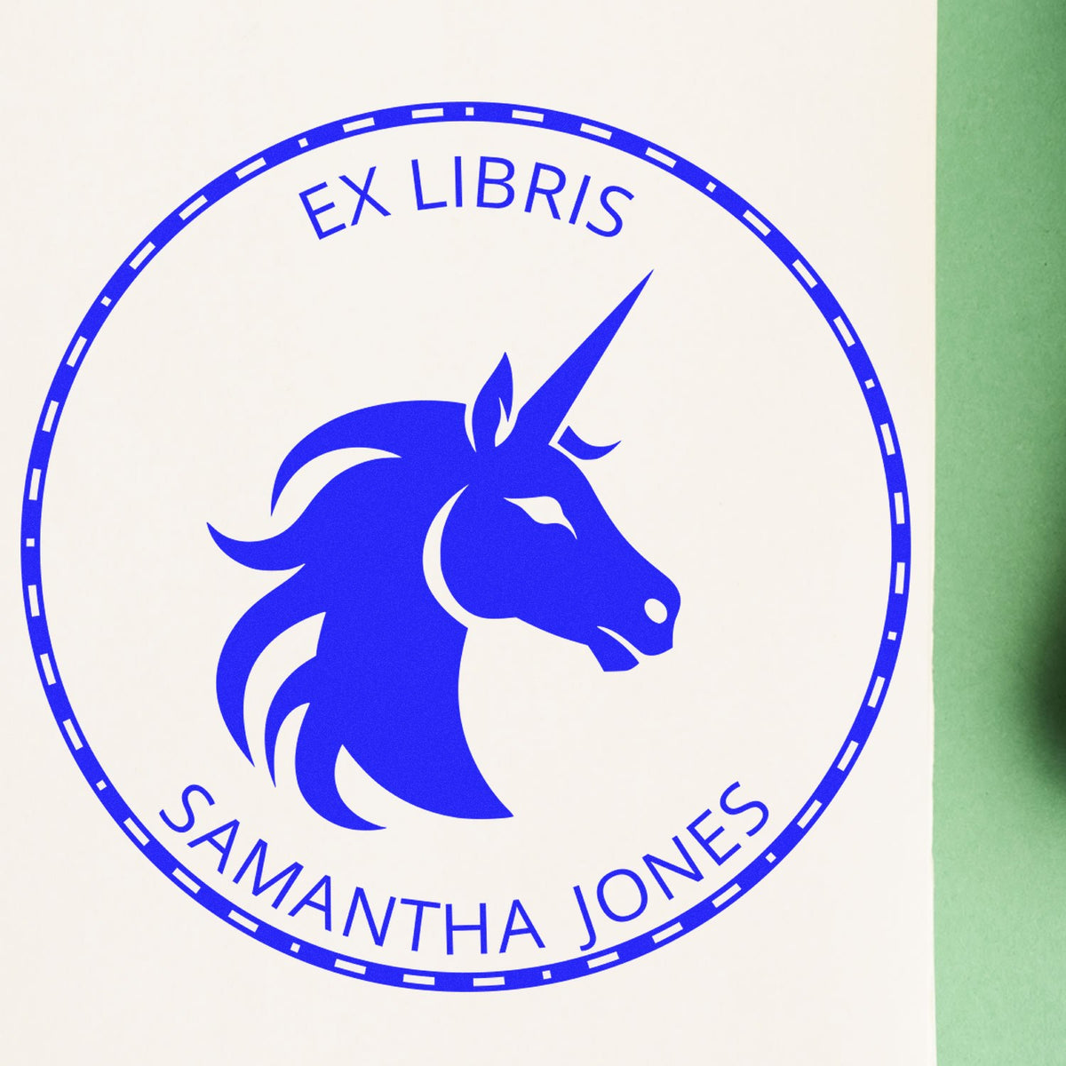 Blue ex libris stamp seal with unicorn head logo and Samantha Jones text on white background