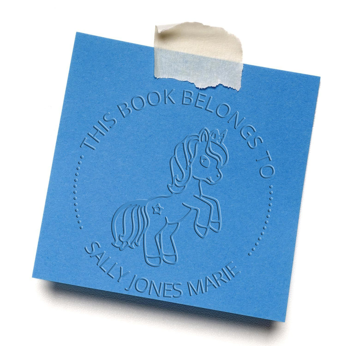ESS Seraphiclight Mythical Unicorn hand-held embossing stamp used on paper, featuring detailed fantasy unicorn design.