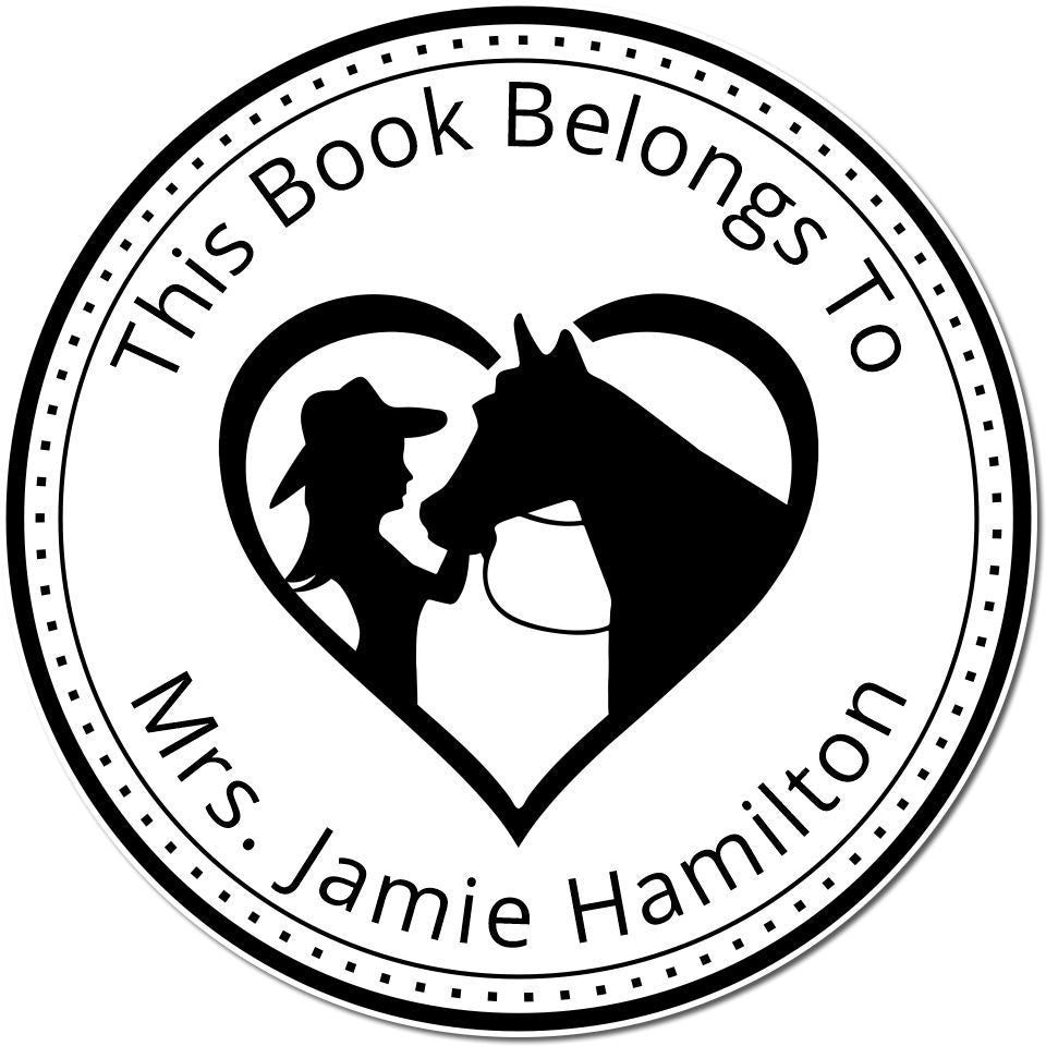 Black-and-white round book stamp seal with heart, horse and rider silhouette, reading This Book Belongs To Mrs. Jamie Hamilton.
