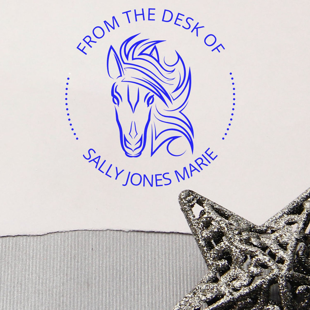 Blue horse-head desk stamp reading From the Desk of Sally Jones Marie, with dotted border and silver glitter star seal.