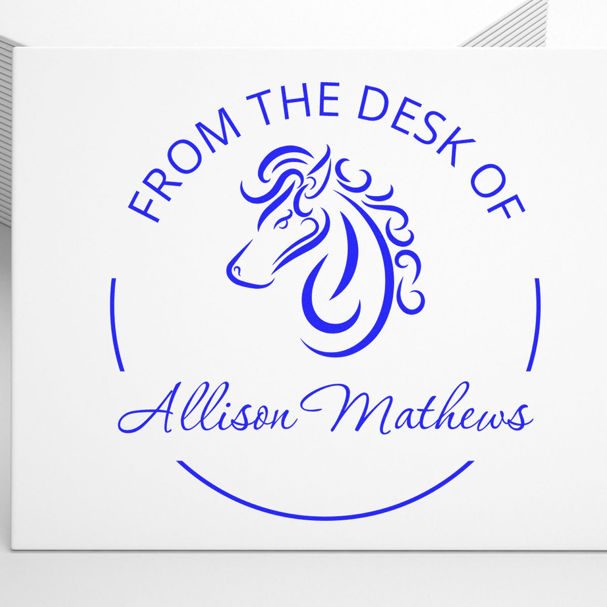 Blue custom round seal stamp with horse logo and From the Desk of Allison Mathews on a white background.