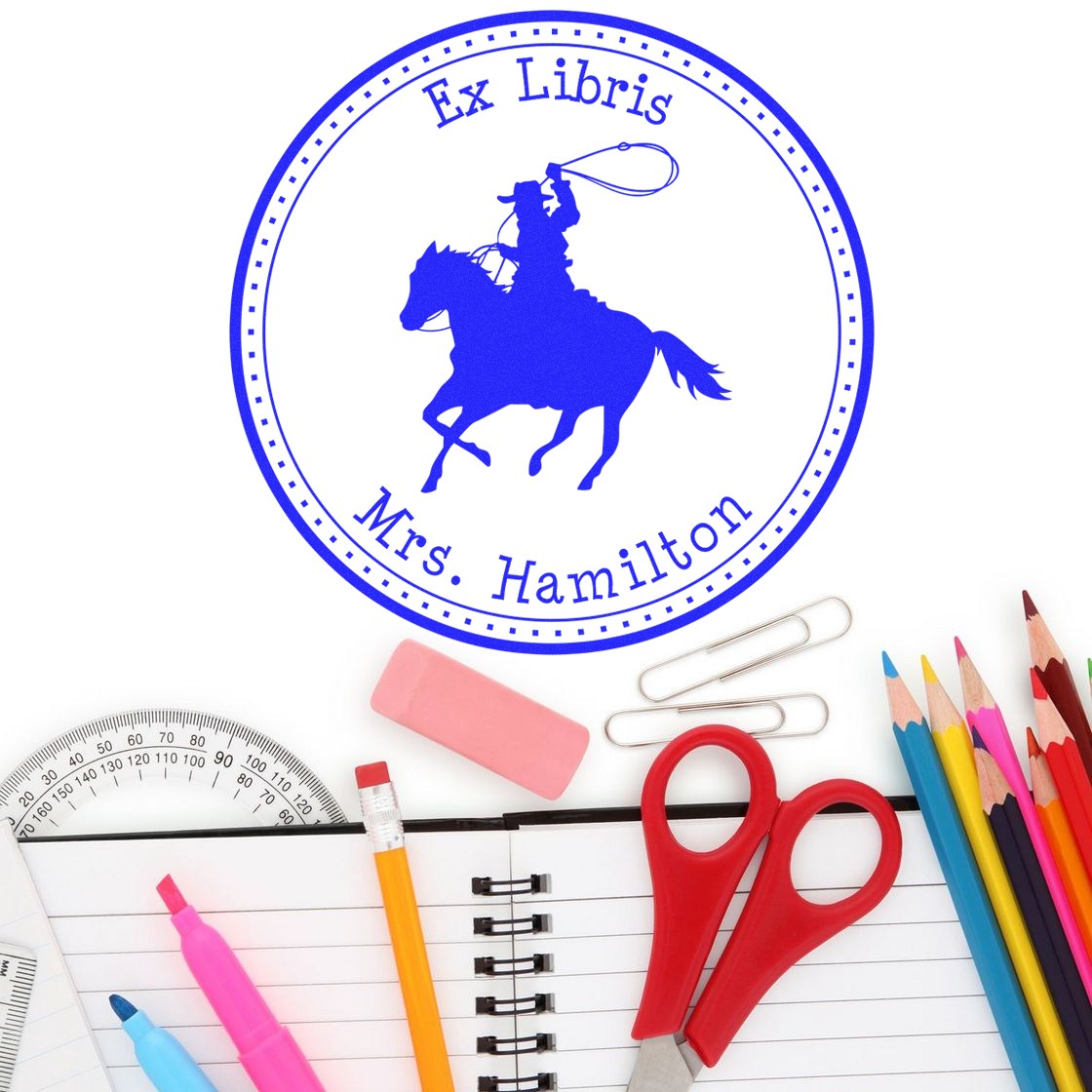 Blue Ex Libris stamp seal with cowboy on horse and Mrs. Hamilton, over white background with school supplies.