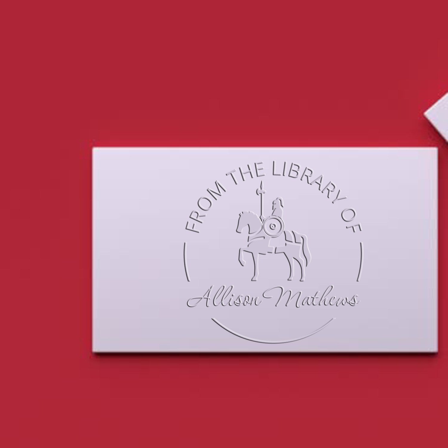 White embossed custom stamp seal with horse-and-rider emblem and Allison Mathews text on a red background.