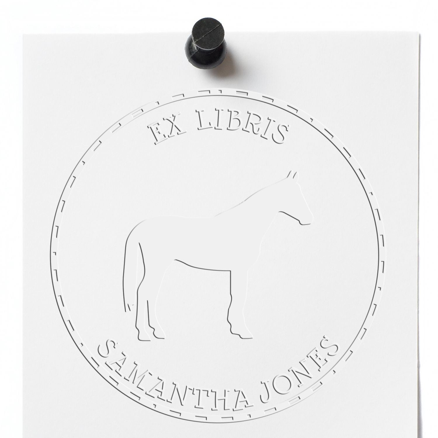 White embossing seal and stamp with black handle, circular horse emblem, and text Ex Libris Samantha Jones.