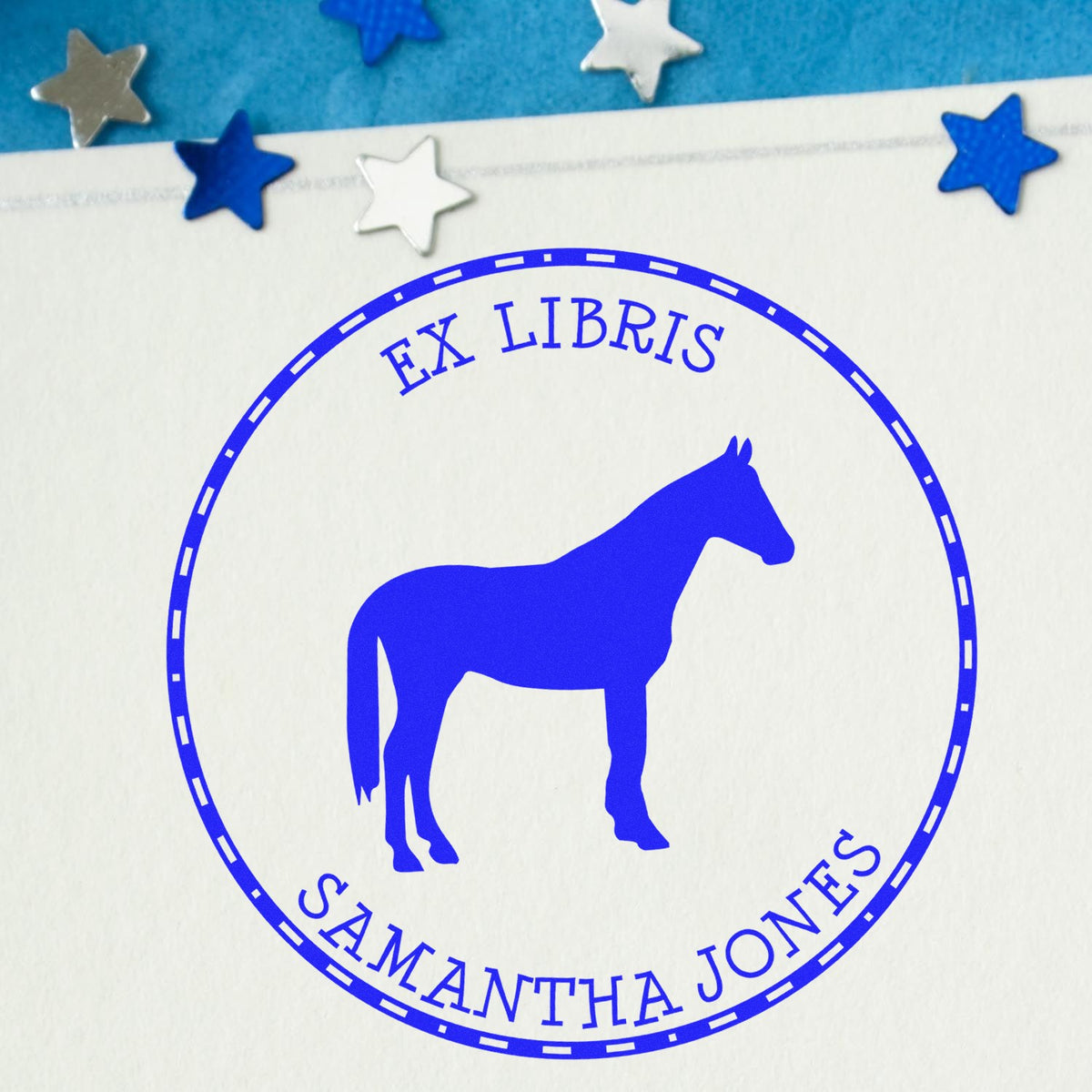 Blue ex libris horse bookplate stamp seal on white paper, with circular border and silver-blue stars.