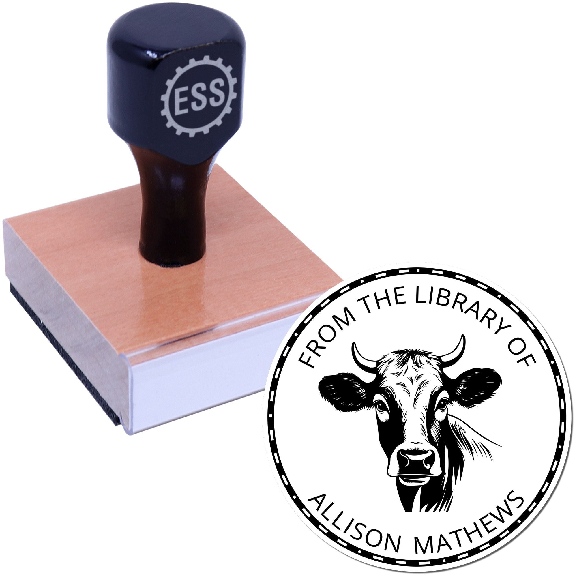 Navy rubber stamp on wood base with custom circular seal reading From the Library of Allison Mathews and cow graphic.