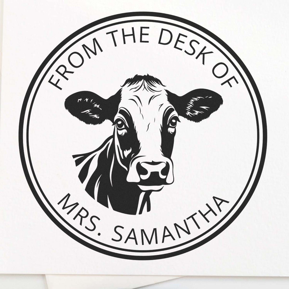 Black circular stamp seal with cow head logo and From the Desk of Mrs. Samantha on a white background.