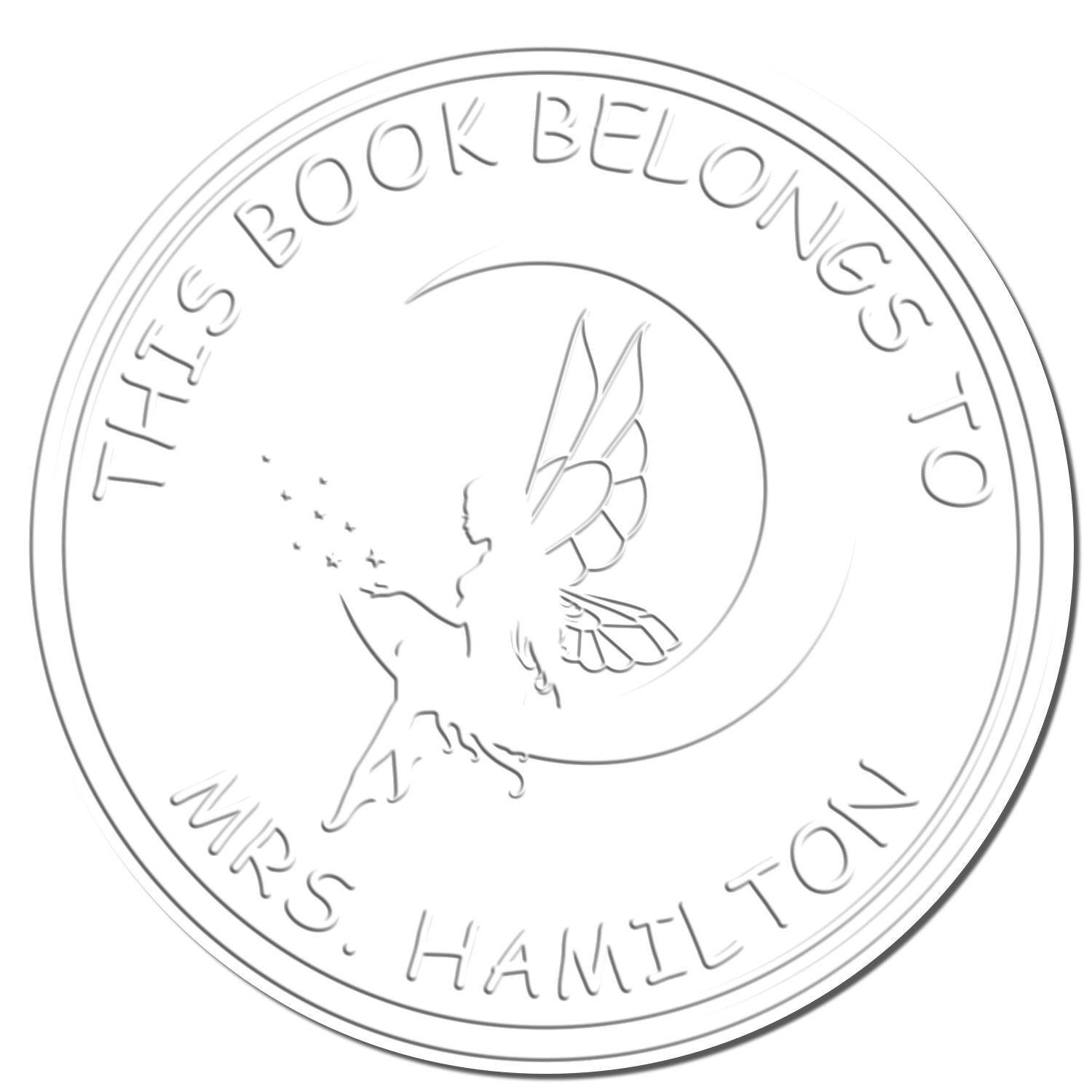White circular embossing stamp seal with fairy silhouette and moon, reading This Book Belongs to Mrs. Hamilton.