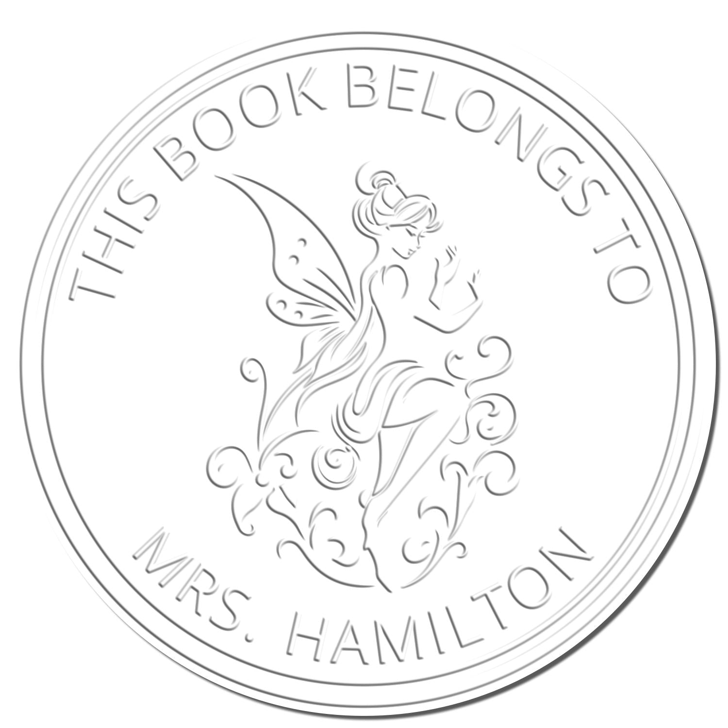 Circular white embossed bookplate stamp and seal with fairy design and text This Book Belongs to Mrs. Hamilton