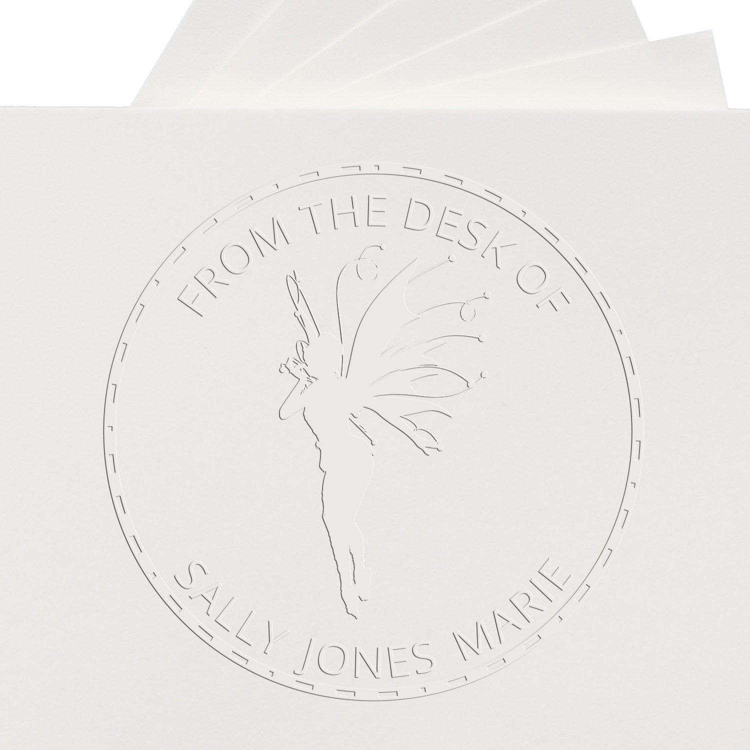 Embossed white circular stamp seal on envelope, with fairy silhouette and From the Desk of Sally Jones Marie text.