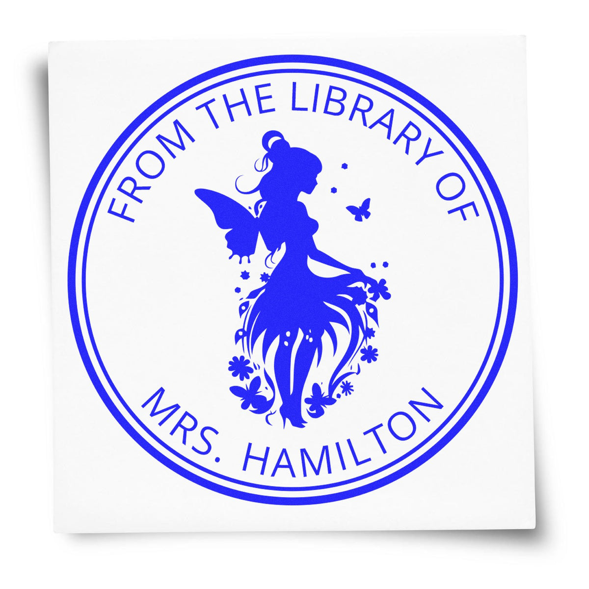 Blue circular library seal stamp with fairy silhouette and text FROM THE LIBRARY OF MRS. HAMILTON.