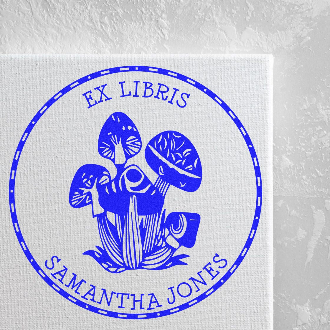 Blue ex libris mushroom stamp seal with circular border and Samantha Jones text on white canvas.