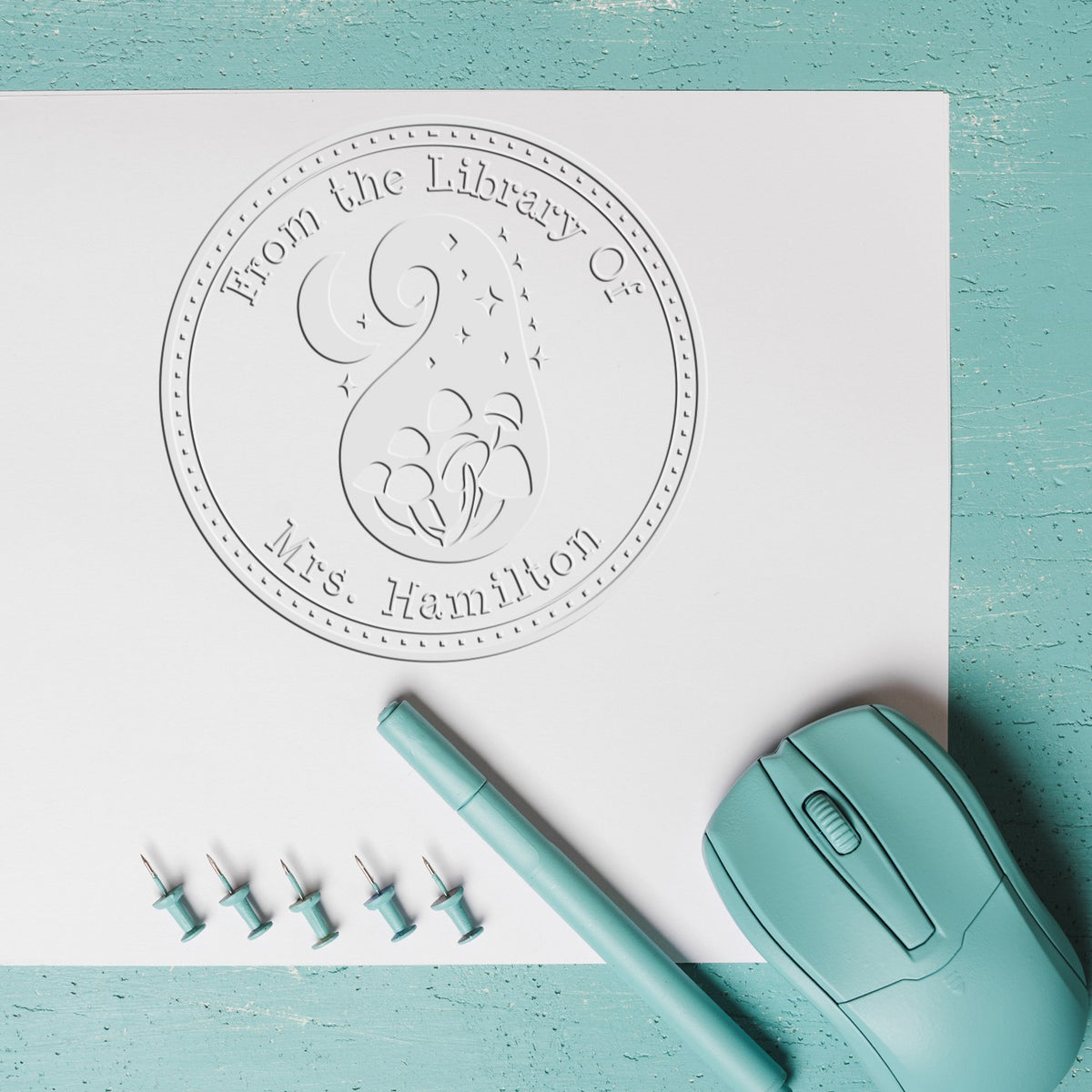 ESS Twilight Tubercle Spore handheld embossing seal for fantasy book property stamping, shown in use with detailed engraved design.