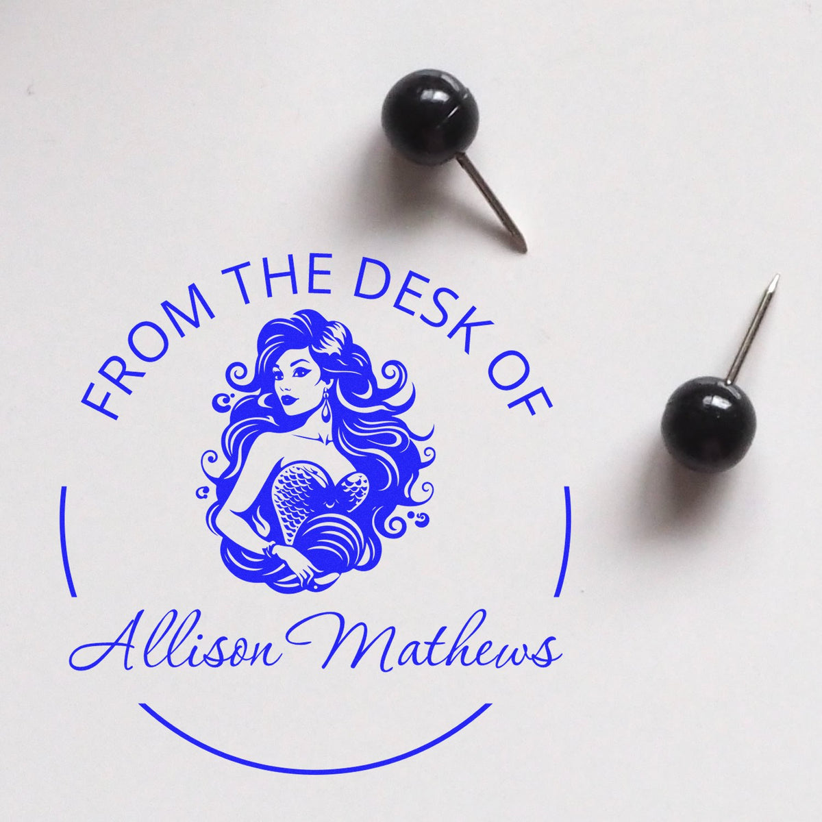 Blue custom desk seal stamp for Allison Mathews with mermaid logo and From the Desk Of text, plus black sealing pins.