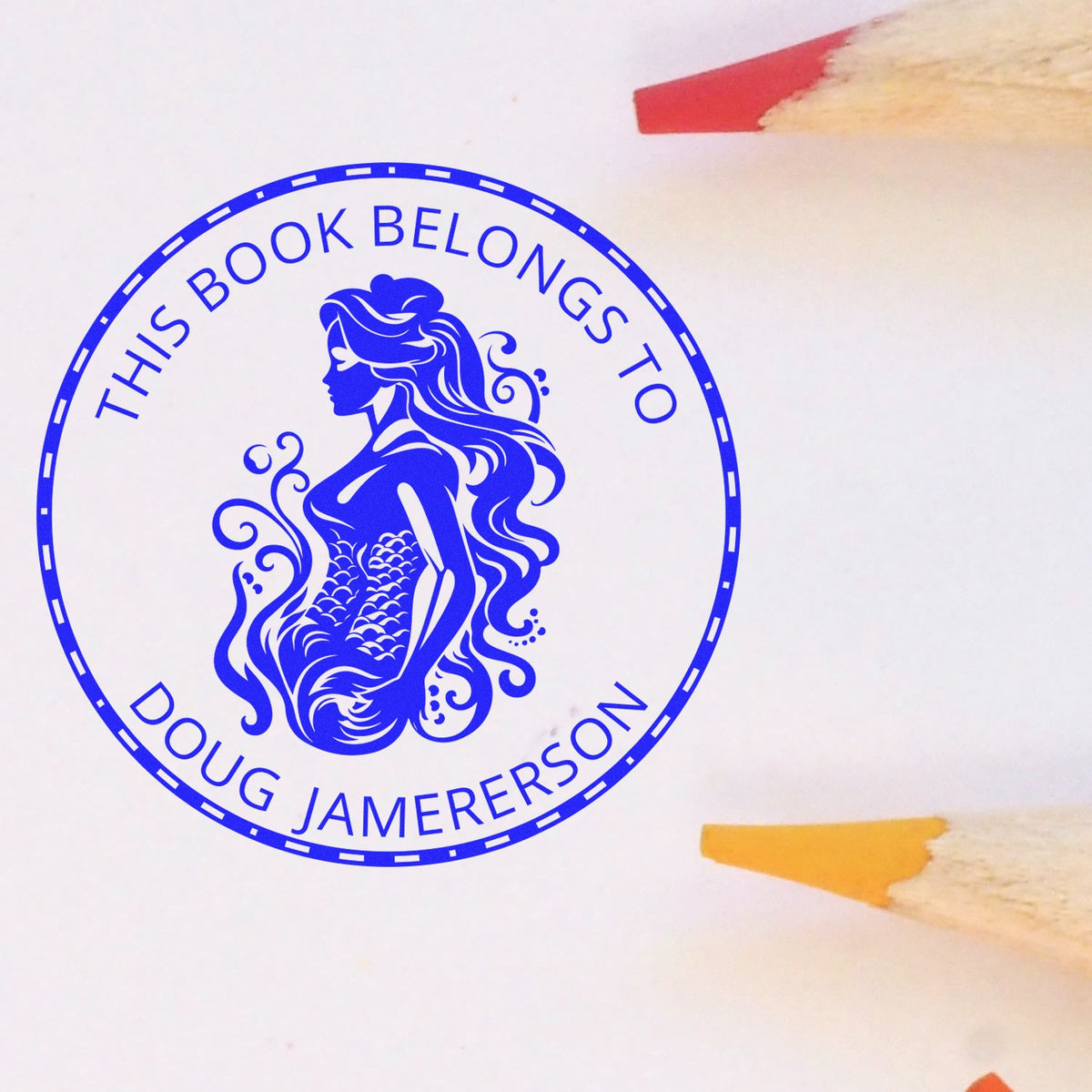 Blue circular stamp seal with mermaid design and This Book Belongs to Doug Jamerson text on white paper.