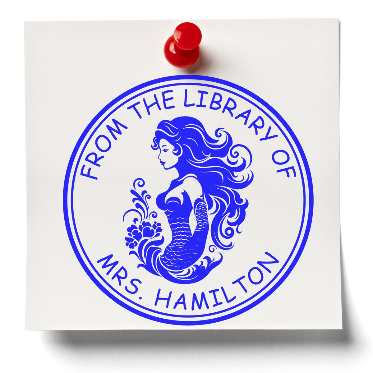 Blue circular library stamp seal on white card with red pushpin, reading From the Library of Mrs. Hamilton.