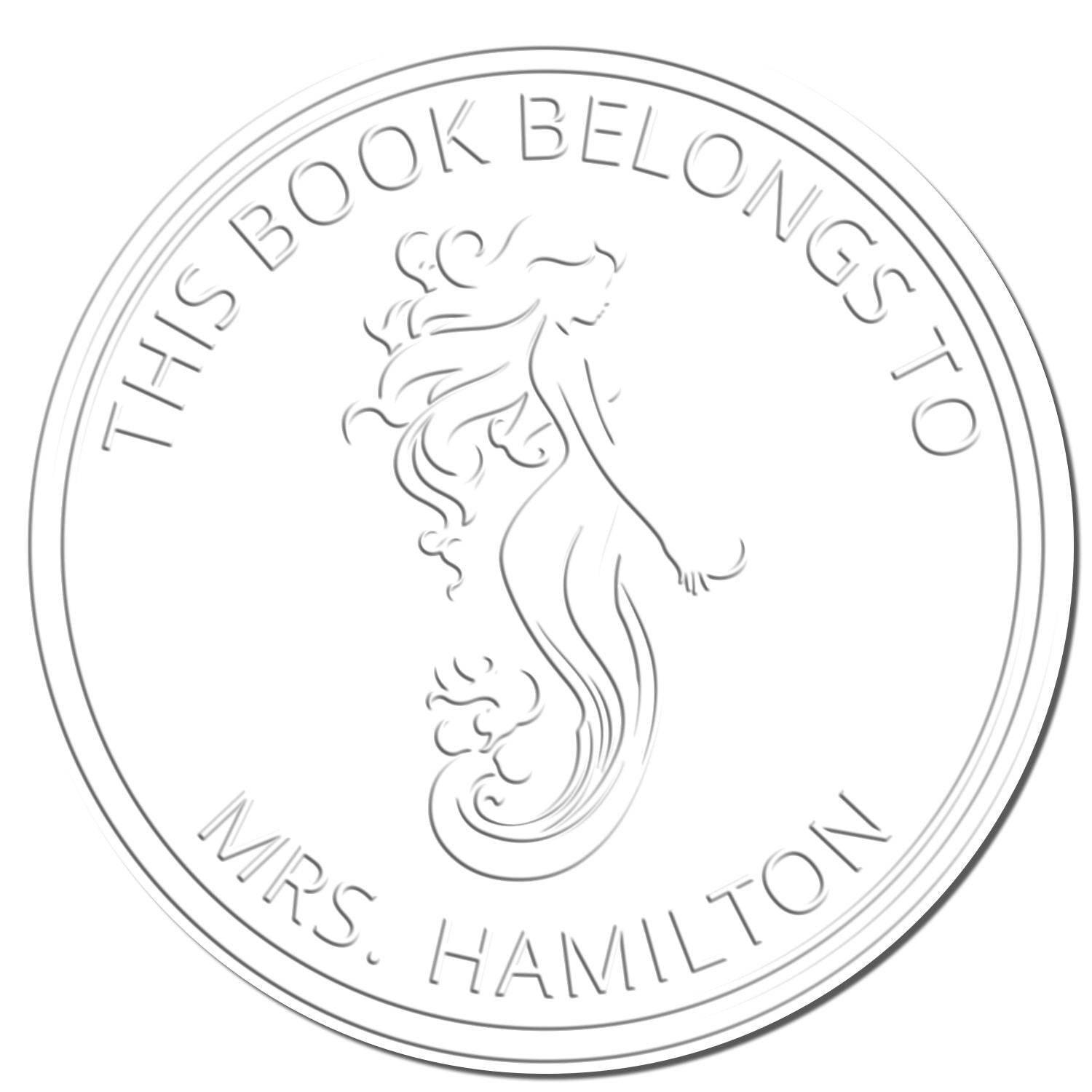 White embossed round book seal stamp with mermaid design and text “This Book Belongs to Mrs. Hamilton.”