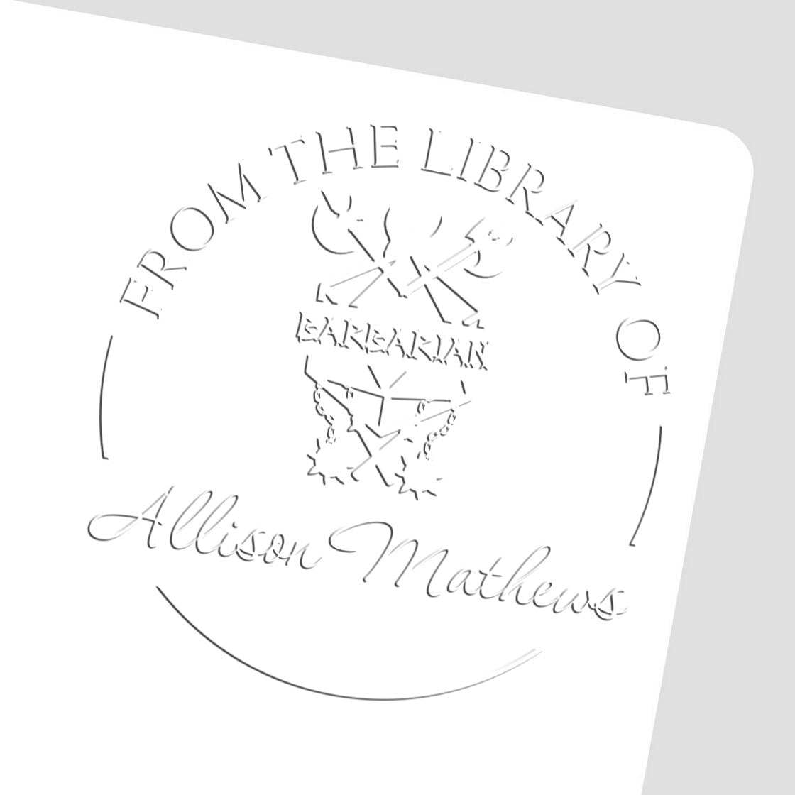 White embossed library stamp seal reading From the Library of Allison Mathews with butterfly emblem and silver-gray lines.