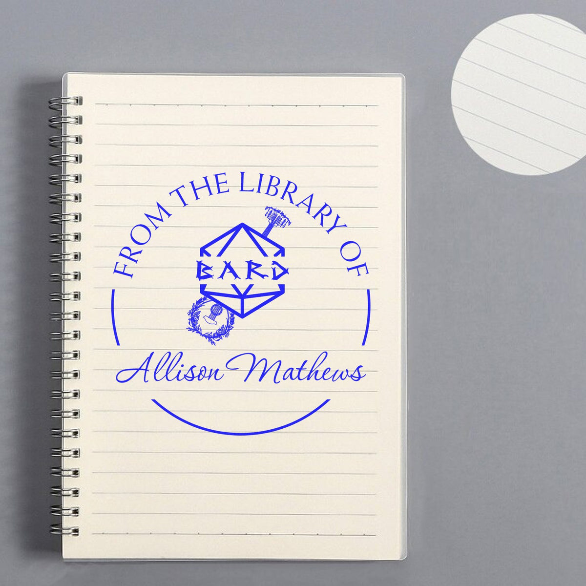 Blue custom library stamp seal on a spiral notebook, reading From the Library of Ward Allison Mathews.