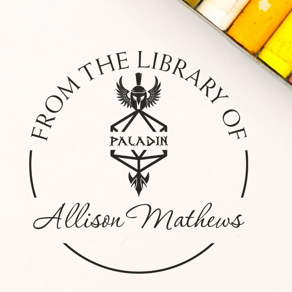 Custom black stamp and wax seal for Allison Mathews, From the Library of Paladin, with winged helmet emblem on white background.