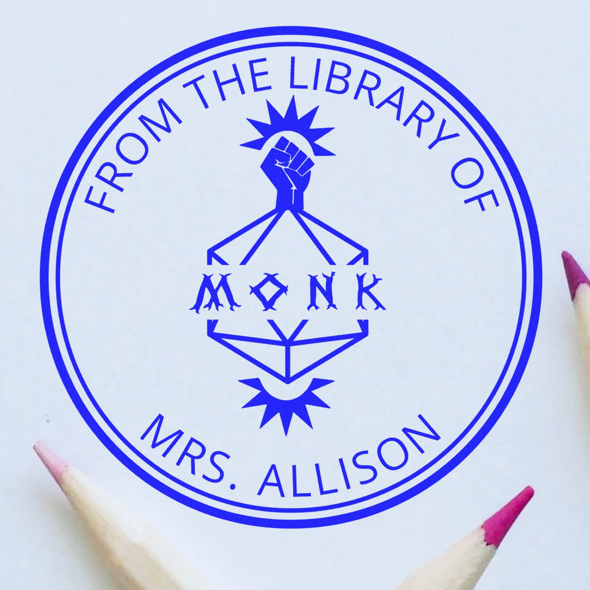 Blue custom library stamp seal reading From the Library of Mrs. Allison with a raised fist emblem.