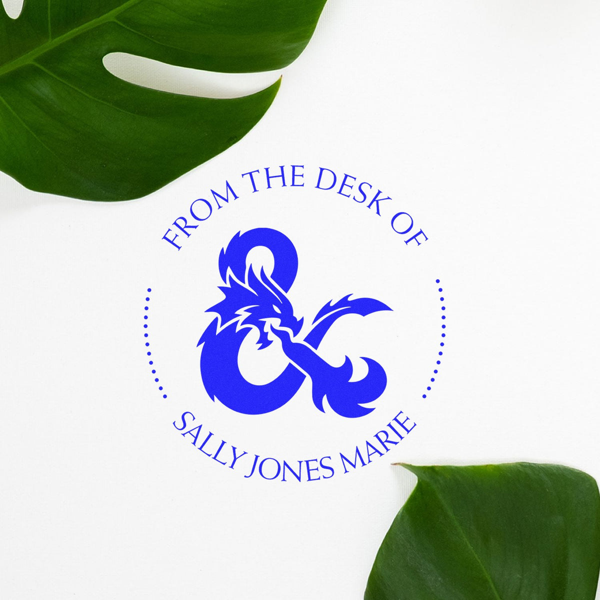 Blue custom stamp and seal logo with dragon emblem and Sally Jones Marie text on white, framed by green leaves.