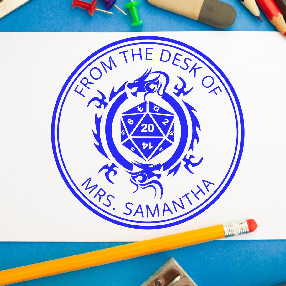 Blue custom stamp seal reading From the Desk of Mrs. Samantha with dragon and dice emblem on white paper.