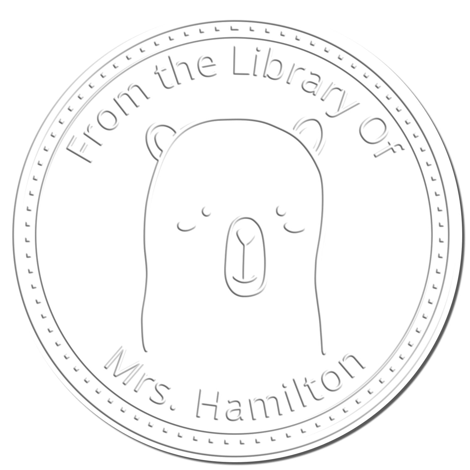 Embossing seal featuring a Soft WhiskerTwist cartoon animal design, perfect for a custom-made book collection. Includes customizable text for a new address stamp. Circular design with "From the Library Of" and "Mrs. Hamilton" text.